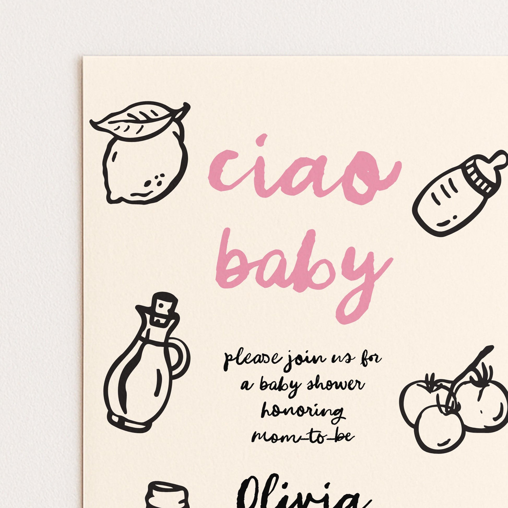 The image is a baby shower invitation featuring a pink and black color scheme with various baby-related items such as a bottle, a lemon, and tomatoes.