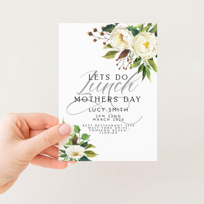 a person holding a card with a floral design and text on it.