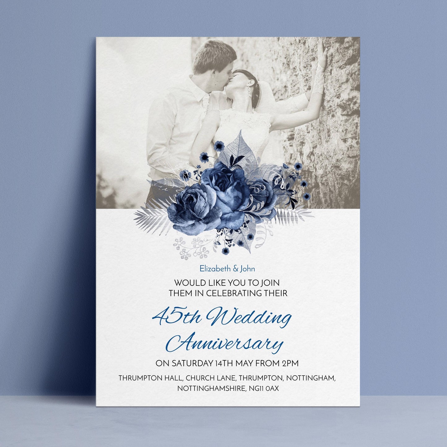 A black and white photograph of a couple embracing, with a floral design above them. The text below the image announces a 45th wedding anniversary celebration.