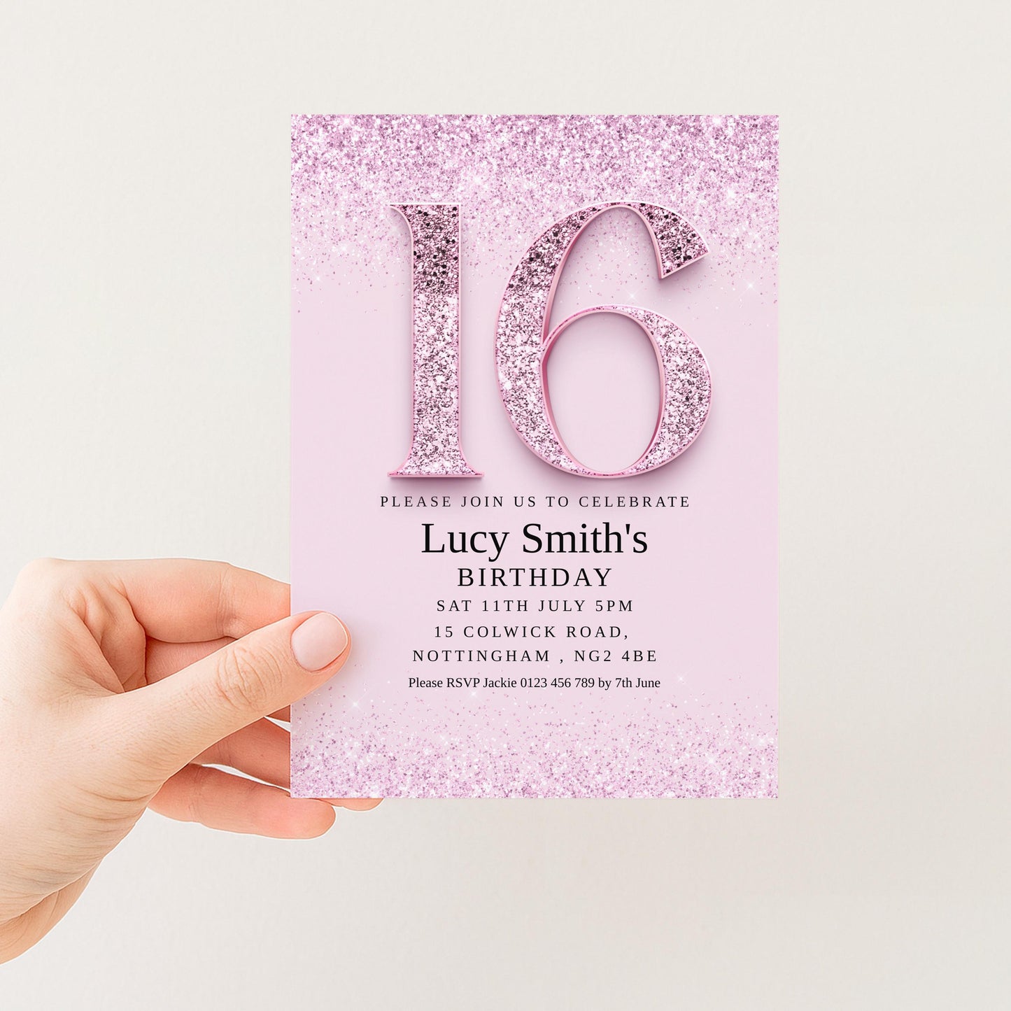 a hand holding a pink birthday invitation card with the number 16 and glittery details.