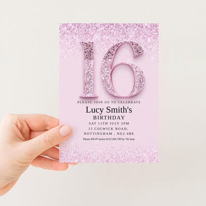 a hand holding a pink birthday invitation card with the number 16 and glittery details.