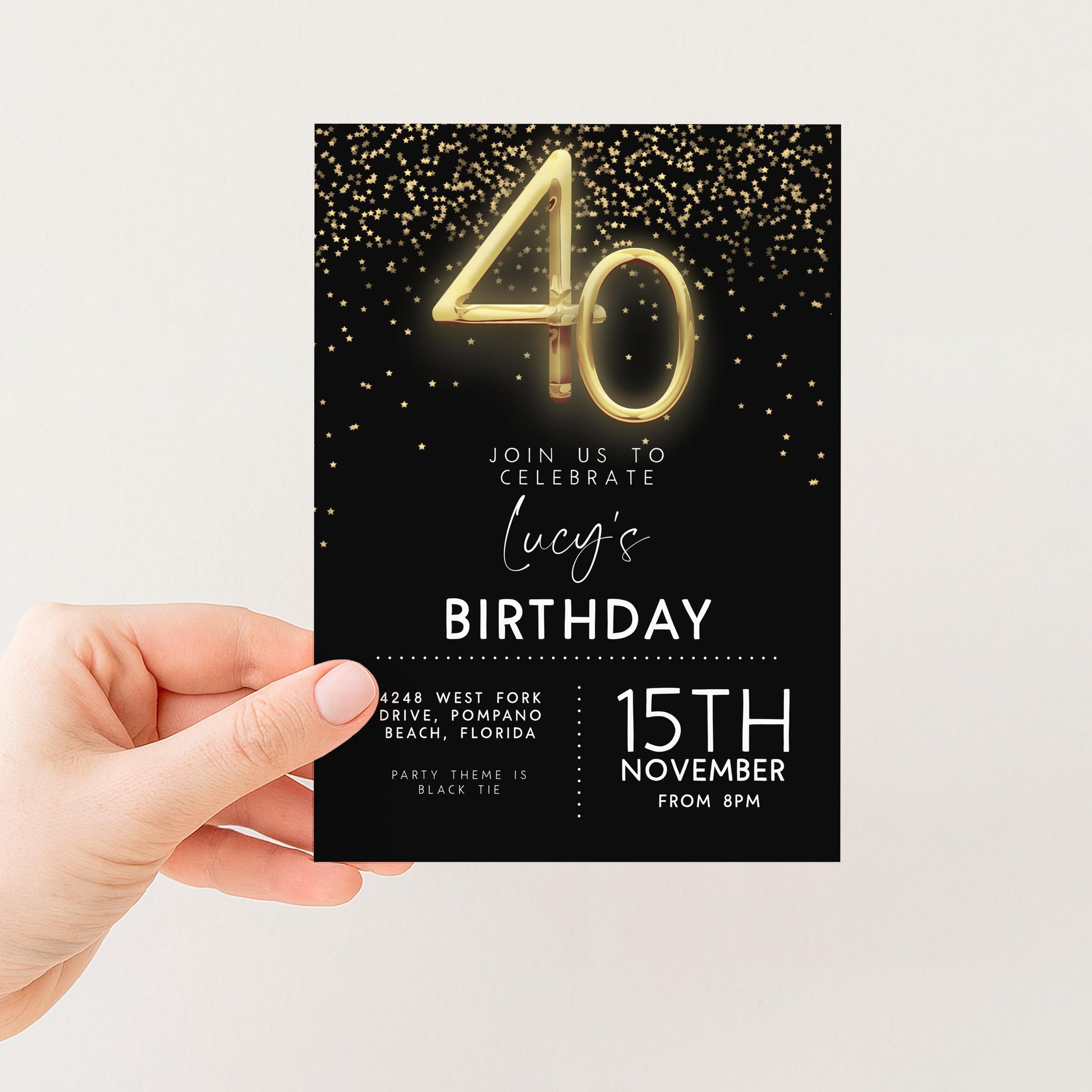 a hand holding a birthday invitation card with a black background and gold glitter. The card features the number 40 and invites guests to celebrate Lucy's birthday.