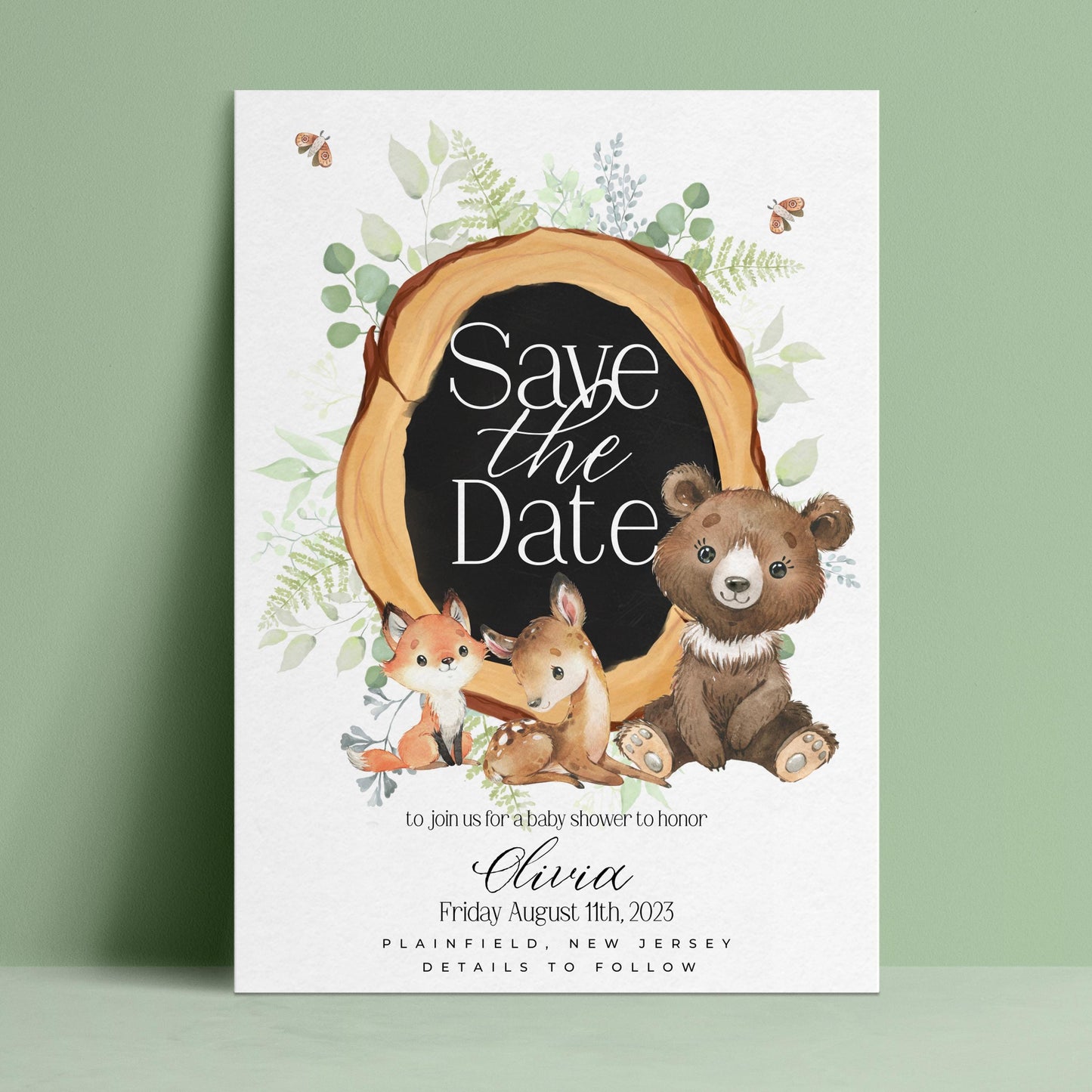The image is a white card with a black border, featuring illustrations of a bear, a fox, and a deer, along with a "Save the Date" message.