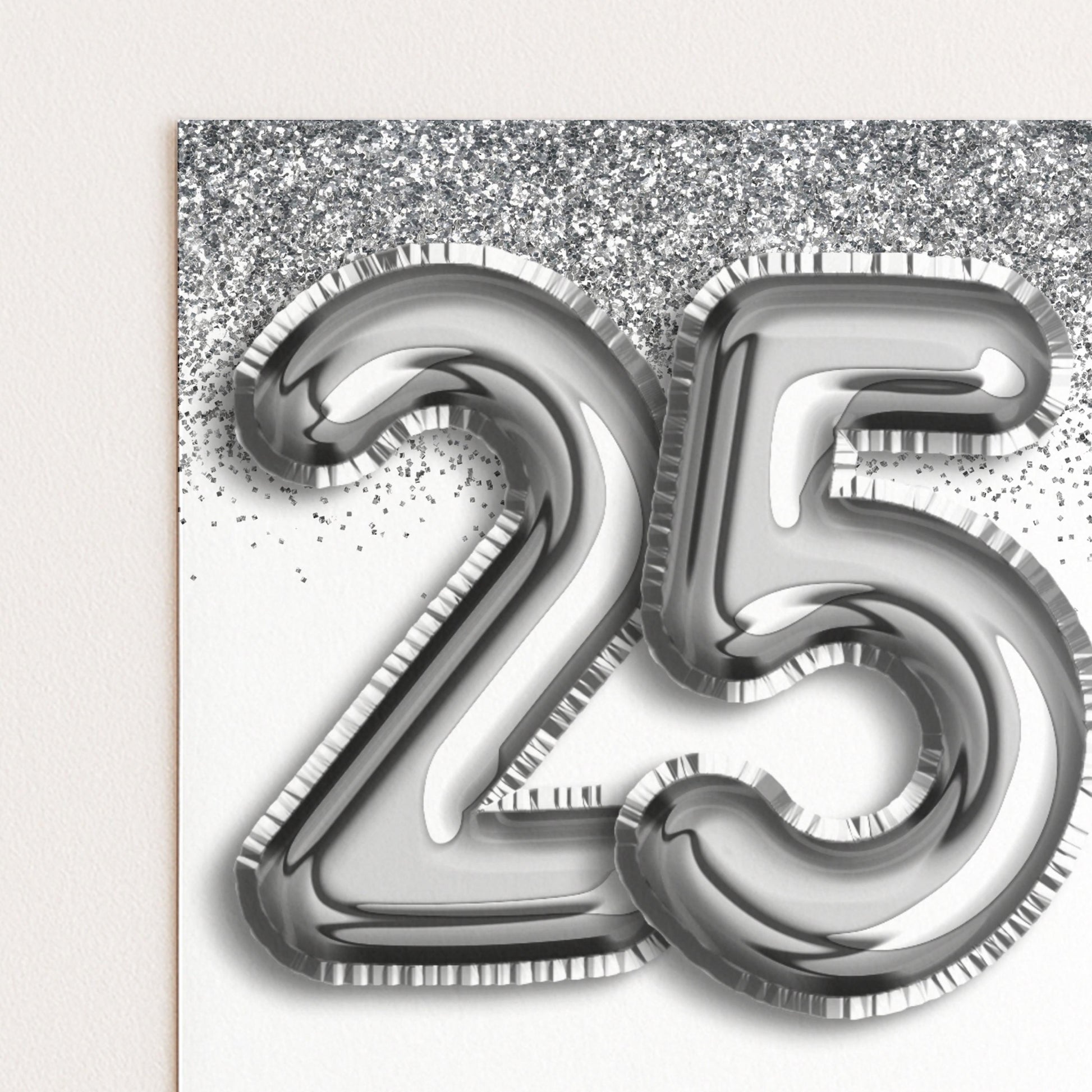 a large number 25 made of shiny silver foil or metallic material, with a glittery background.