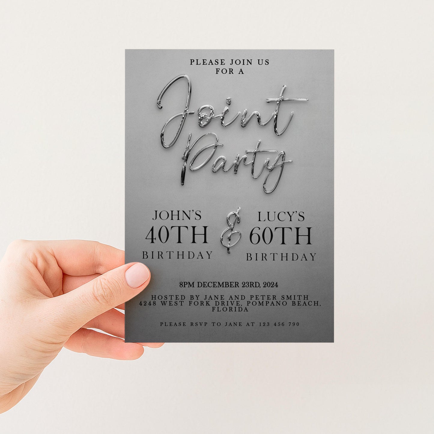 a person's hand holding a gray birthday invitation card.