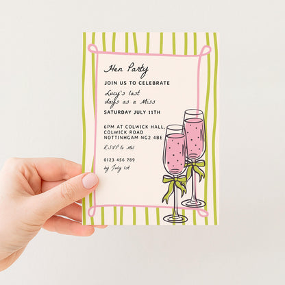 The image is a hand holding a party invitation card with a pink and green striped border. The card features illustrations of champagne glasses and text inviting guests to a "HEN PARTY" to celebrate Lucy's last days as a Miss. The event is scheduled for Saturday, July 11th, at 6PM at COLWICK HALL, COLWICK ROAD, ROTTHAM CAM N2 4BE, and guests are requested to arrive by July 1st.