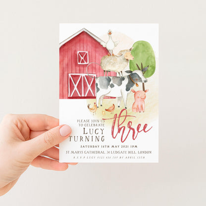 The image is a birthday invitation for a three-year-old girl named Lucy, featuring a red barn and various farm animals such as a cow, pig, and sheep.