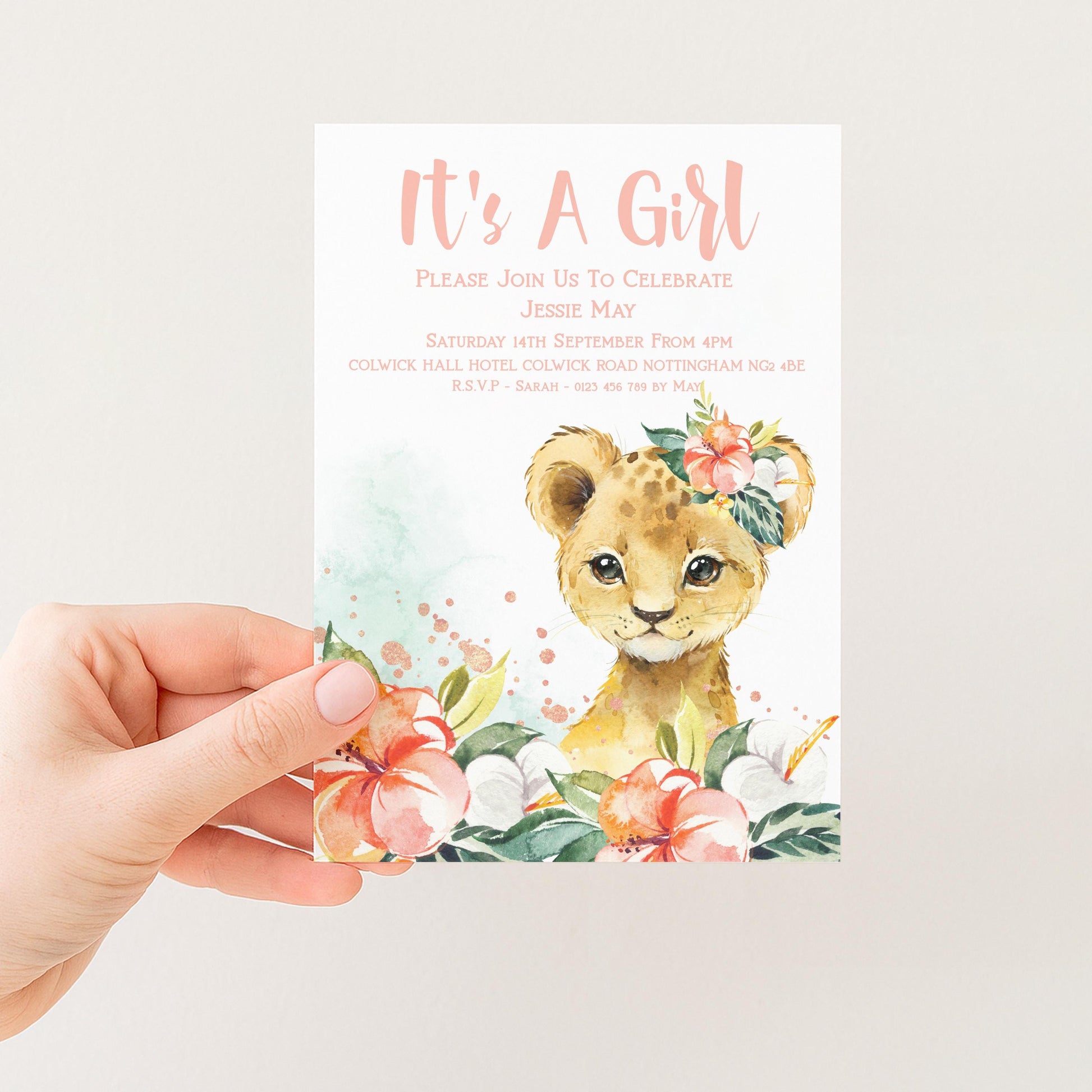 The image is a hand holding a baby girl's birthday invitation card.