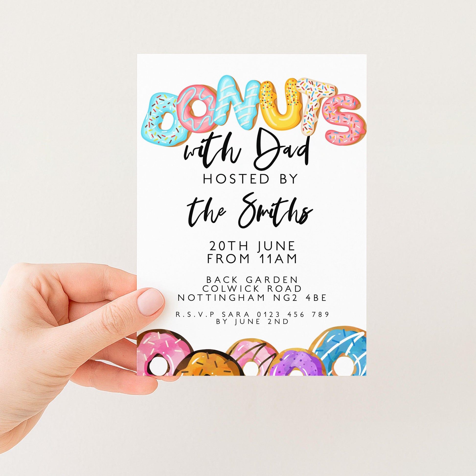 The image is a colorful invitation card with the word "Donuts" written in large letters, surrounded by various donut illustrations. The card is being held by a person's hand, and it appears to be a party invitation or event related to donuts.