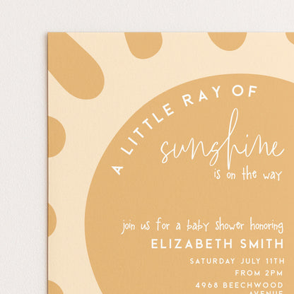 The image is a baby shower invitation with a sun-shaped design and text.