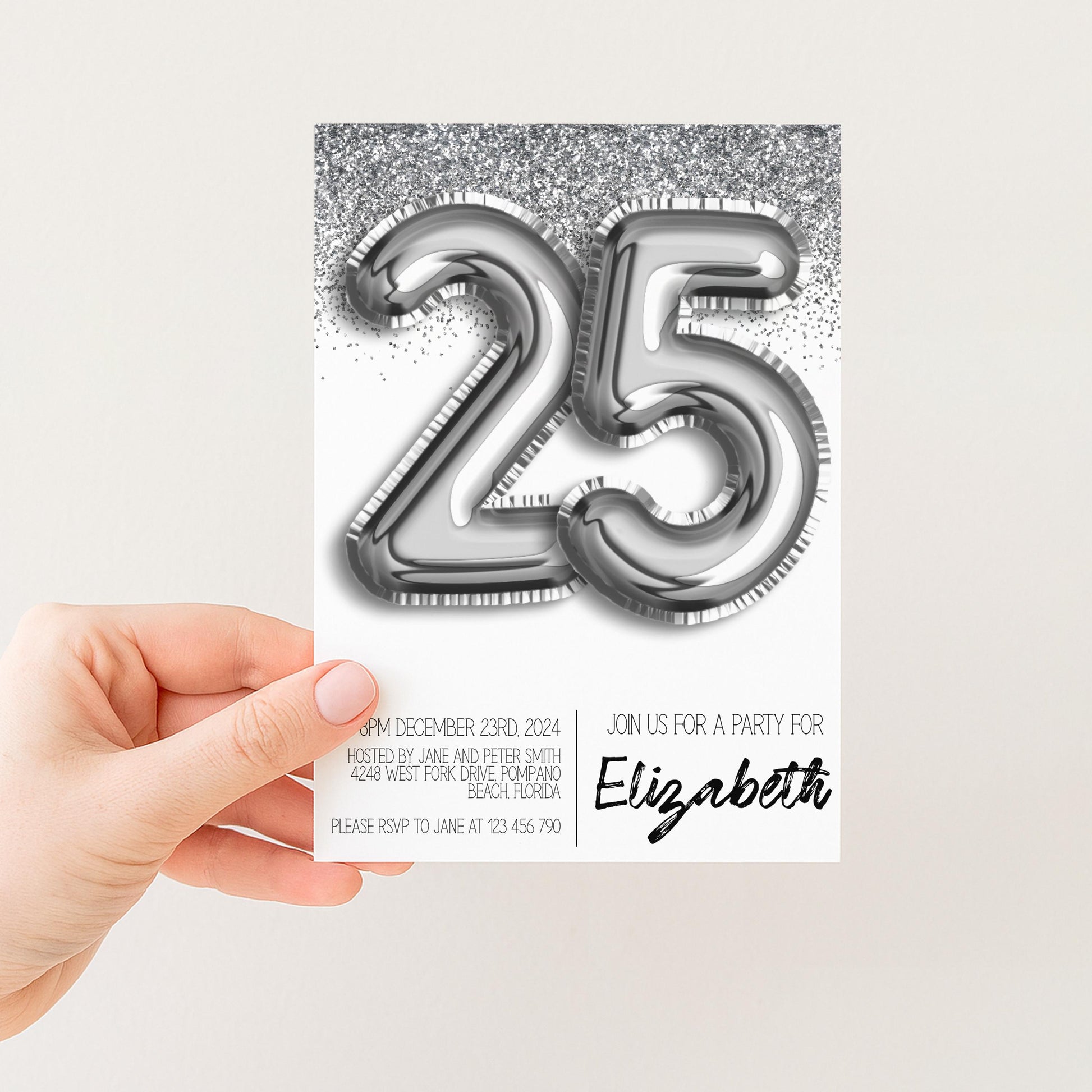a hand holding a party invitation card with a large number 25 and a glittery background.