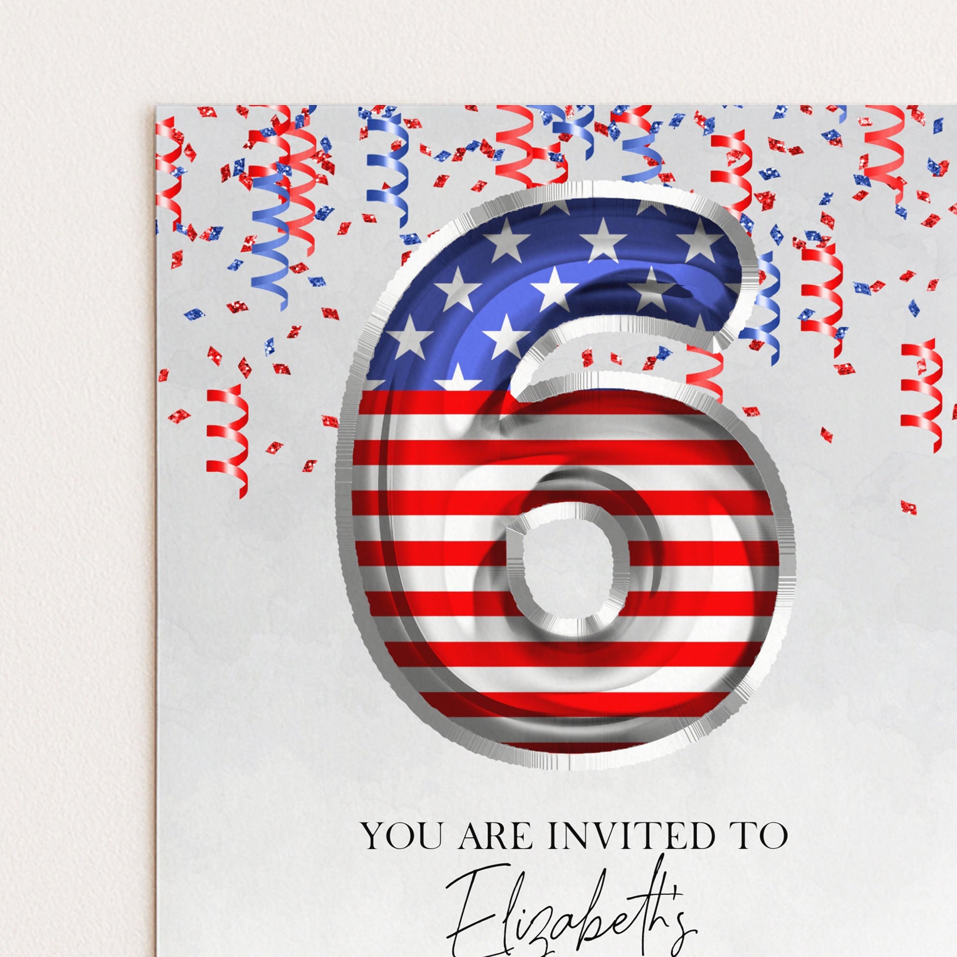 a large number 6 with an American flag design, surrounded by confetti and streamers, indicating a celebration or event.