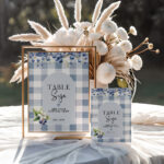 Two editable blueberry gingham table signs in 5x7 and 8x10 sizes with floral decor on a soft table setting