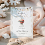 Baby-Q Save the Date invitation in sand with shells and pink fabric background