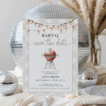 Baby-Q Save the Date invitation in front of disco balls and pampas grass